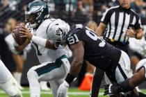 Philadelphia Eagles quarterback Jalen Hurts (1) is sacked by Raiders defensive end Yannick Ngak ...