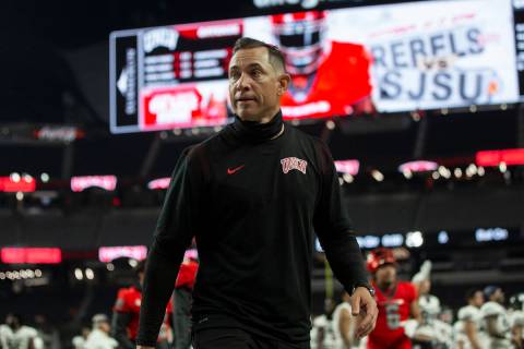 UNLV Rebels head coach Marcus Arroyo walks off the field after losing to Utah State at the end ...