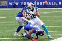 New York Giants' Reggie Ragland, rear, and Logan Ryan (23) attempt to tackle Carolina Panthers' ...