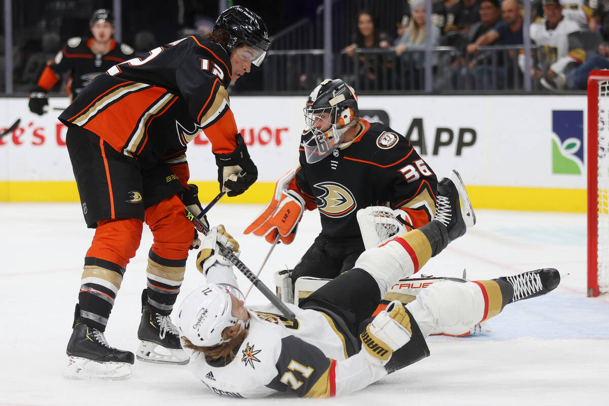 Anaheim Ducks left wing Sonny Milano (12) knocks down Vegas Golden Knights center William Karls ...