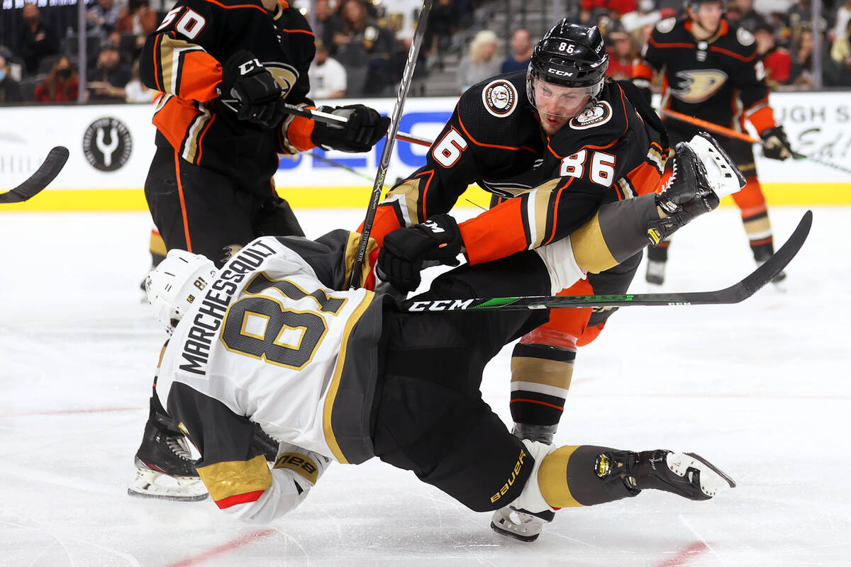 Anaheim Ducks defenseman Simon Benoit (86) knocks down Vegas Golden Knights center Jonathan Mar ...