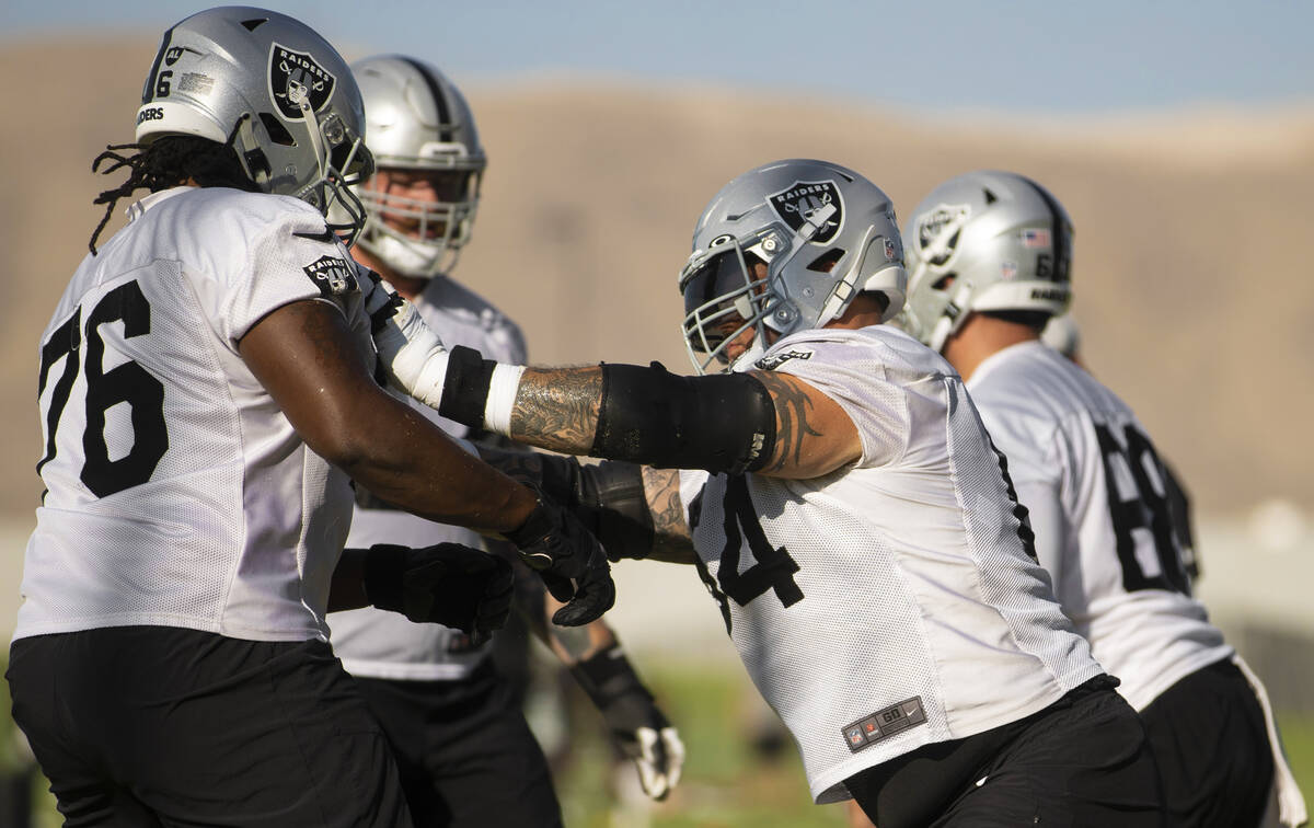 Raiders offensive guard Richie Incognito (64) blocks Raiders offensive guard John Simpson (76) ...