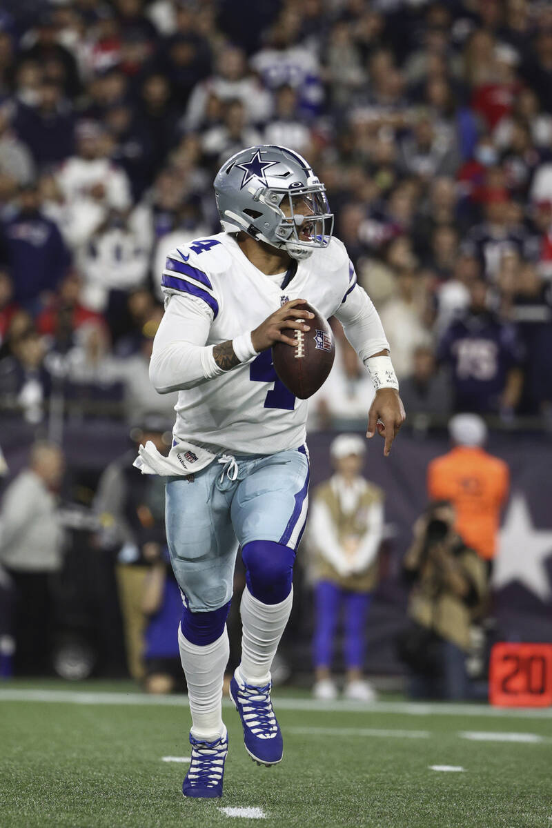 Dallas Cowboys quarterback Dak Prescott scrambles during an NFL football game against the New E ...