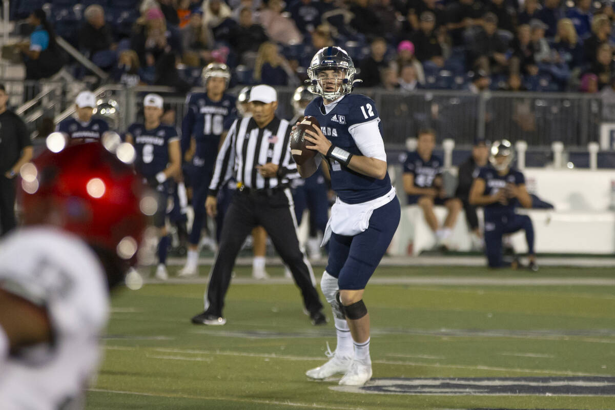 Nevada quarterback Carson Strong (12) looks to throw against UNLV in the first half of an NCAA ...