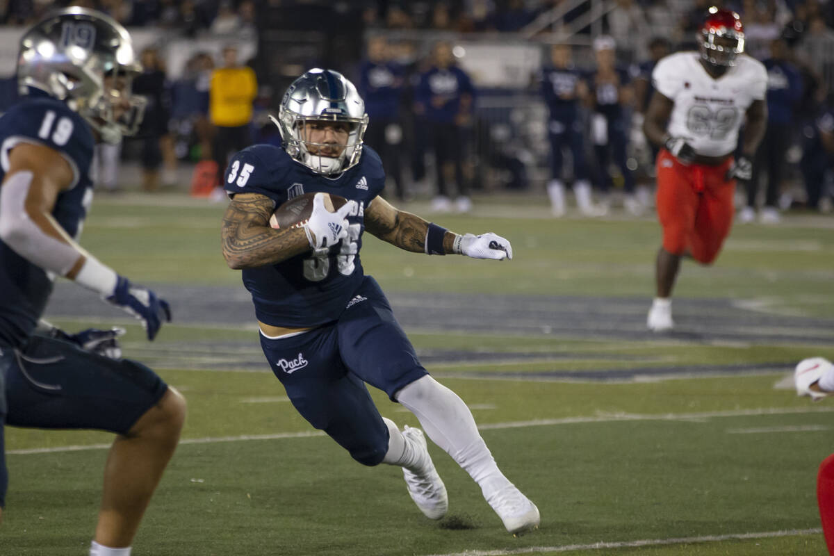 Nevada running back Toa Taua (35) carries against UNLV during the first half of an NCAA college ...
