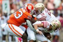 Clemson defensive tackle Ruke Orhorhoro (33) sacks Florida State quarterback Jordan Travis (13) ...