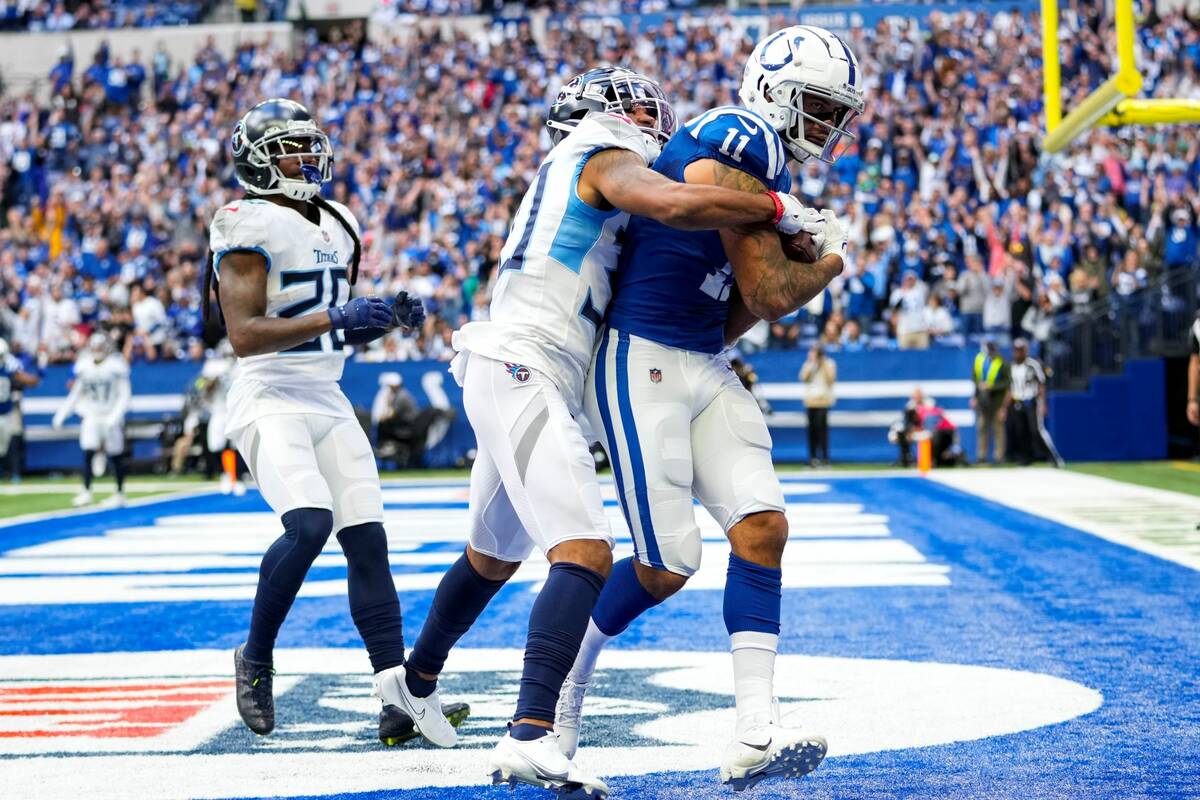 Indianapolis Colts wide receiver Michael Pittman (11) makes a catch for a touchdown in front of ...