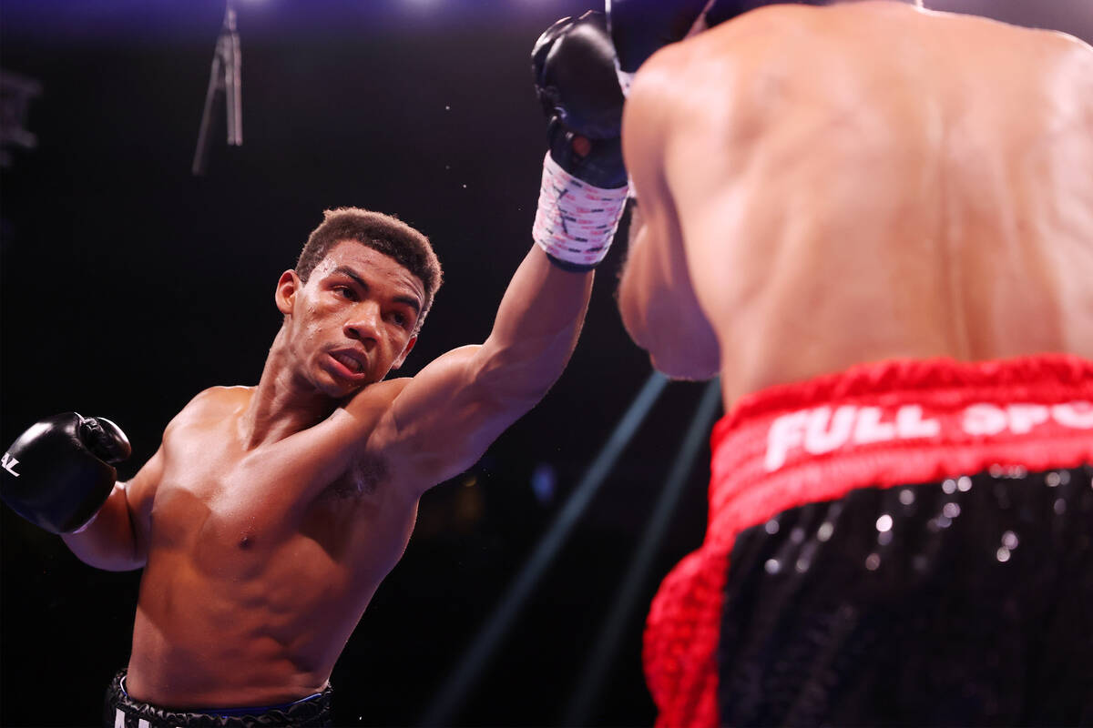 Michel Rivera throws a punch against Jose Matias Romero in the third round of a lightweight bou ...