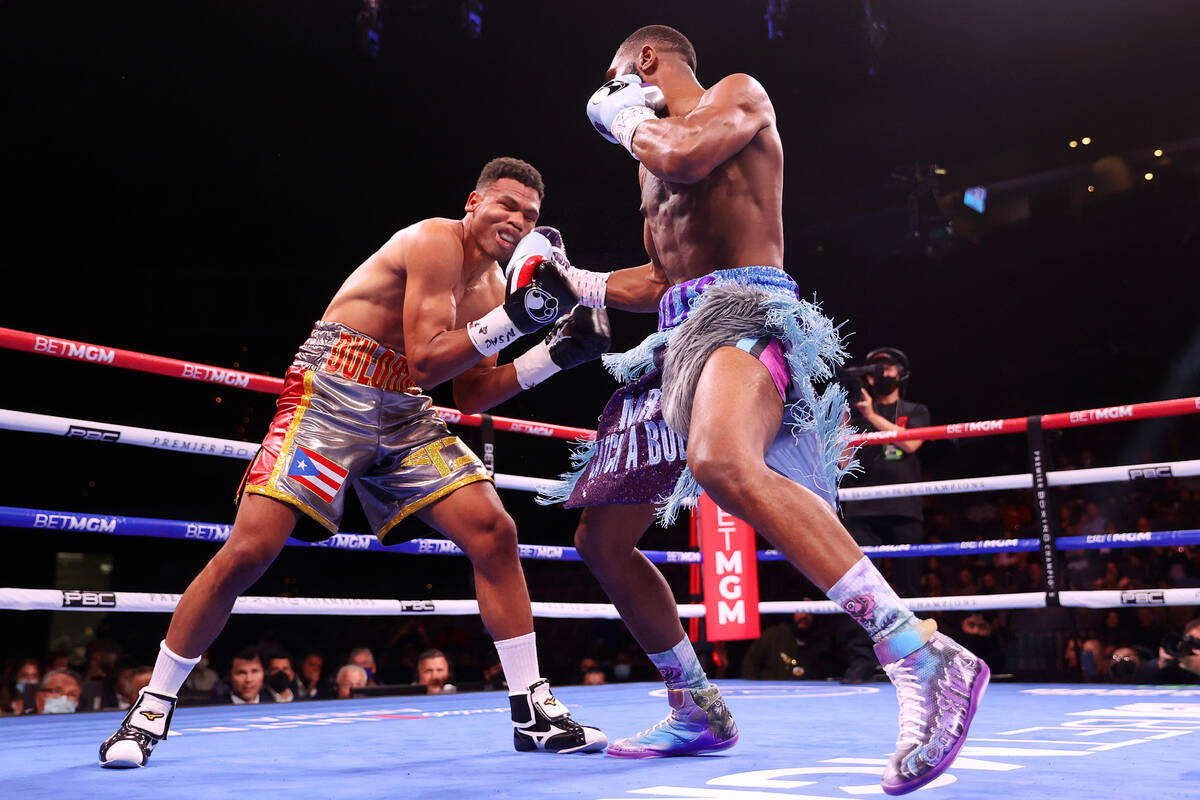 Jaron Ennis, right, connects a punch against Thomas Dulorme in the first round of a welterweigh ...
