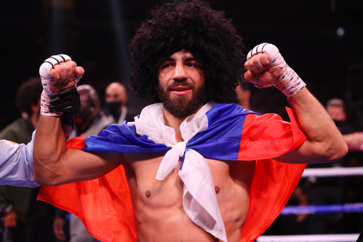 Radzhab Butaev raises his hands in victory after his technical knockout win against Jamal James ...