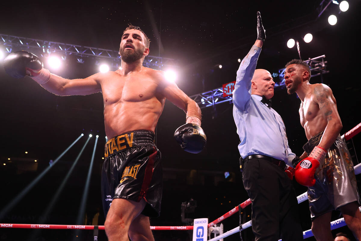 Radzhab Butaev, left, walks away after the referee stopped his fight against Jamal James to win ...