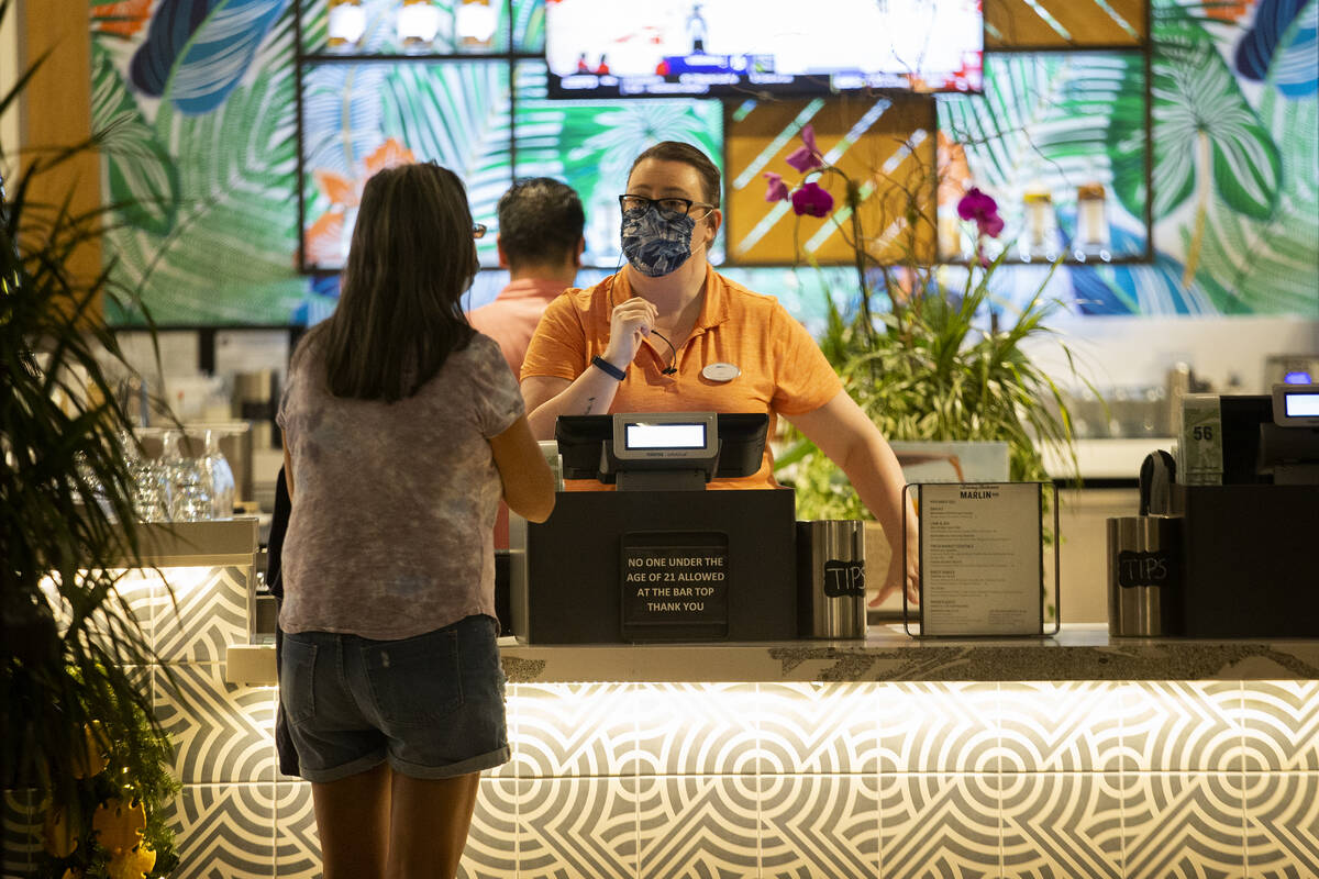 Bartender Jess Lilley helps a customer at Tommy Bahama Marlin Bar & Store in Town Square La ...