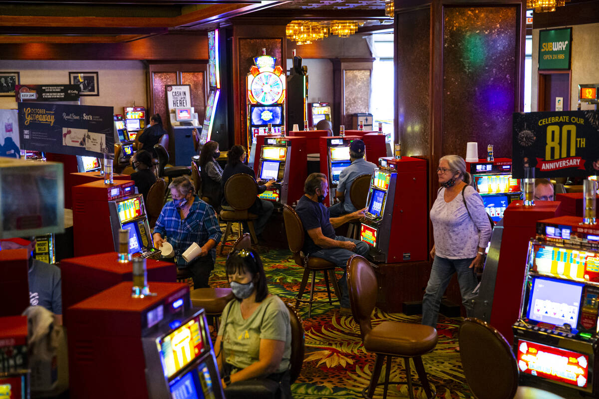 People play on slot machines at the El Cortez in downtown Las Vegas on Wednesday, Oct. 27, 2021 ...