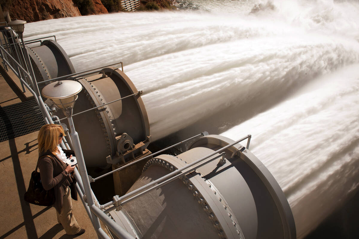 In this photo provided by the Bureau of Reclamation, water rushes from the Glen Canyon Dam as p ...