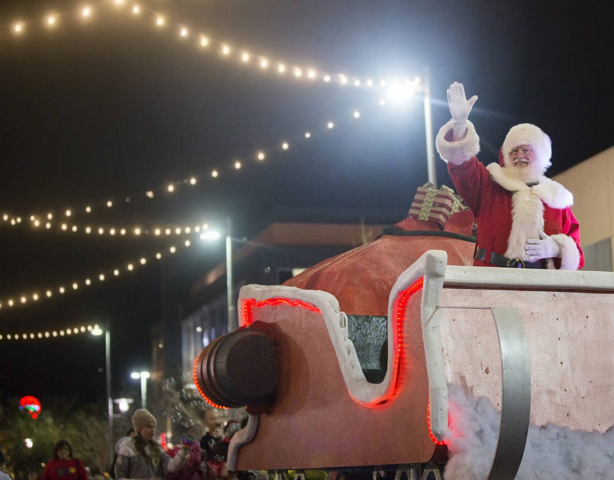 Santa waves to the crowd during the Downtown Summerlin Holiday Parade on Festival Plaza Drive o ...