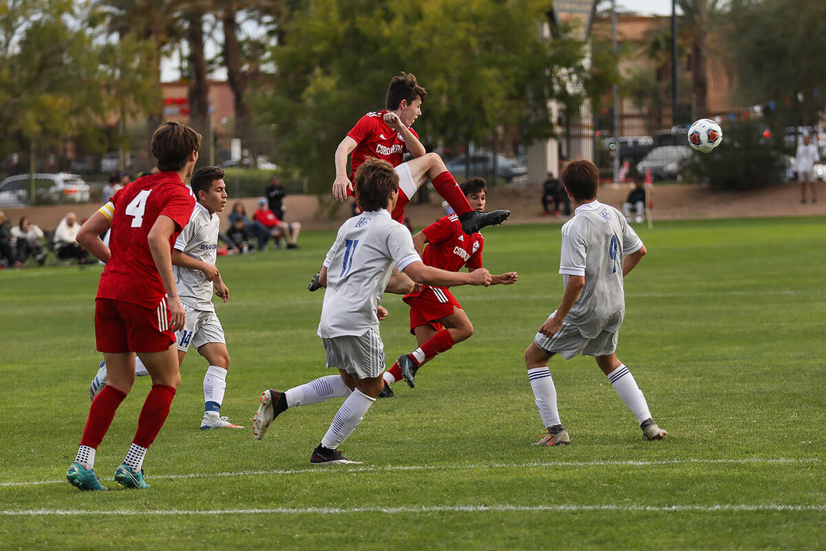 Coronado High Schoolճ Collin Anderson (8) jumps to kick the ball during a Class 5A boys p ...