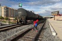 A train sits on tracks over Twain Avenue near Dean Martin Drive after a woman was hit by the tr ...