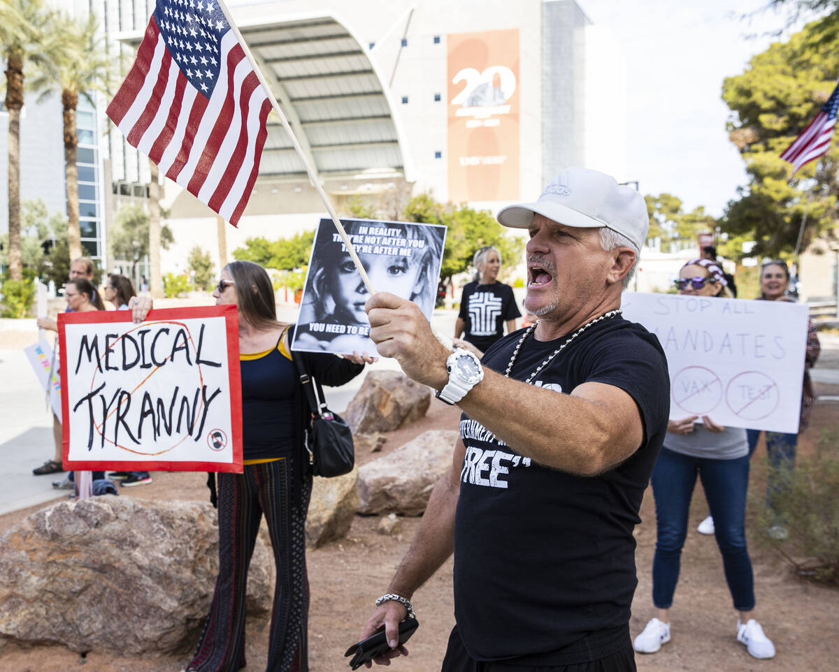 Jay Harrison, center, of Las Vegas and Kim M., left, of Pahrump, Nev., protest against the Nev ...