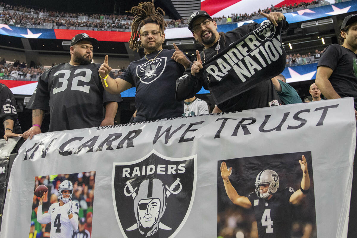 Raiders fans pose before an NFL football game against the Philadelphia Eagles on Sunday, Oct. 2 ...
