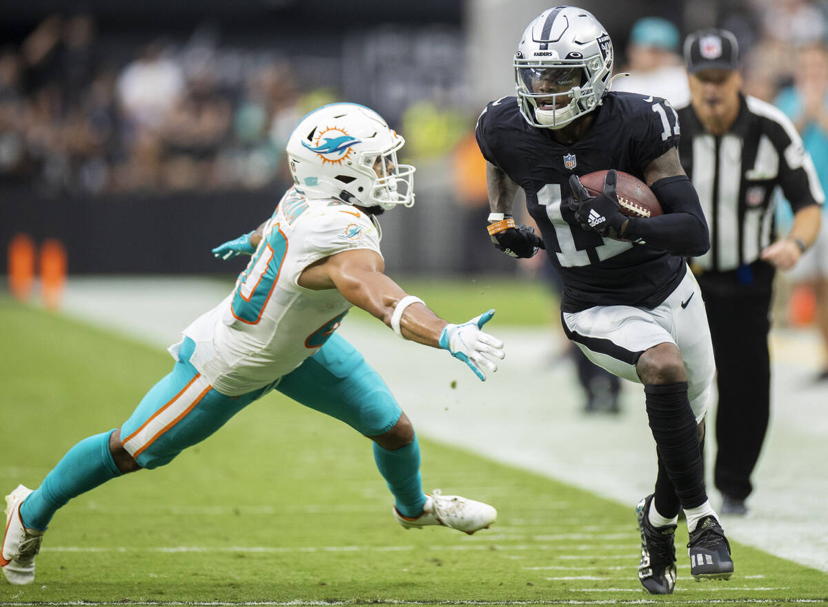 Las Vegas Raiders wide receiver Henry Ruggs III (11) breaks down the sideline past Miami Dolphi ...