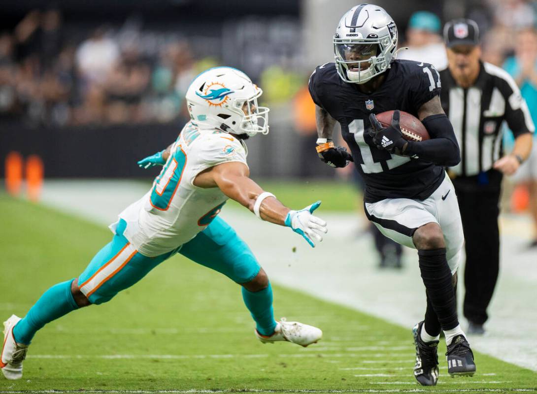 Las Vegas Raiders wide receiver Henry Ruggs III (11) breaks down the sideline past Miami Dolphi ...