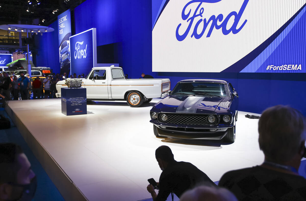 A renovated 1969 Ford Mustang for country music star Keith Urban, right, is pictured alongside ...