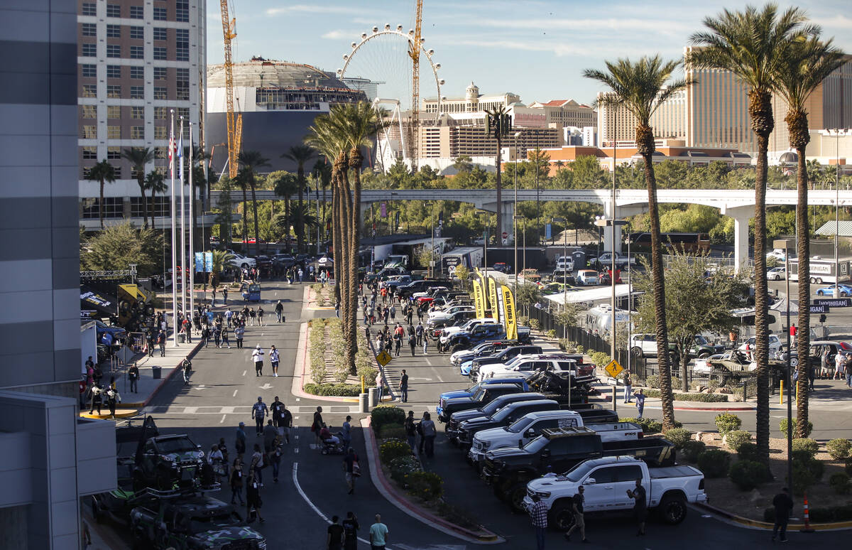 Attendees walk around outside during the Specialty Equipment Market Association, or SEMA, Show ...