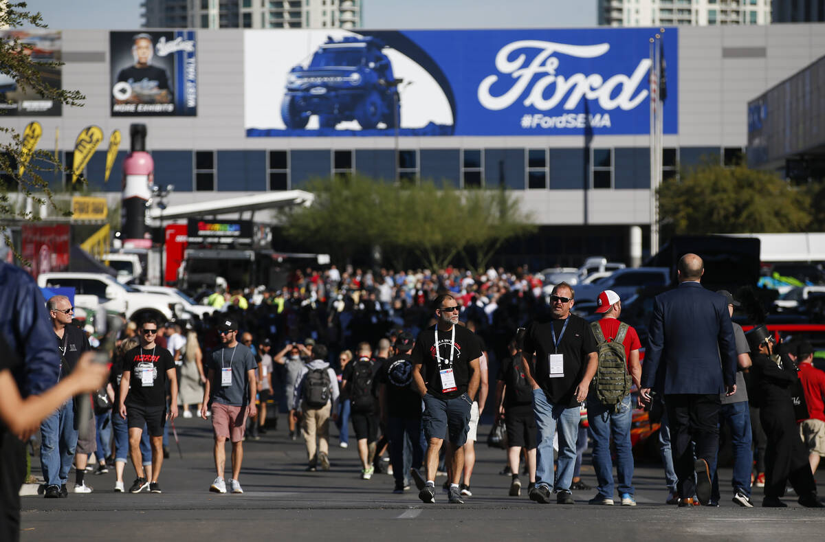 Attendees of the the Specialty Equipment Market Association, or SEMA, Show walk around outside ...