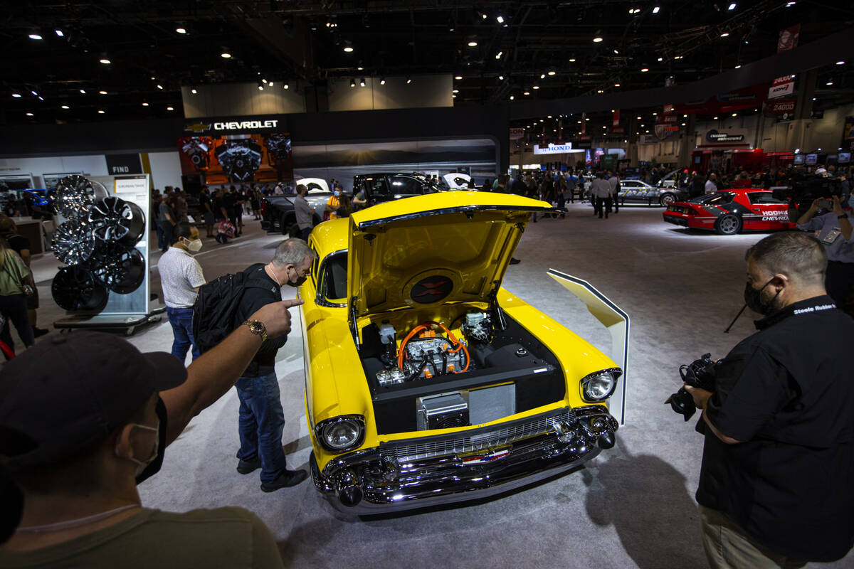 Attendees check out an all-electric 1957 Chevy Bel Air 210 concept, dubbed Project X, at the Ch ...