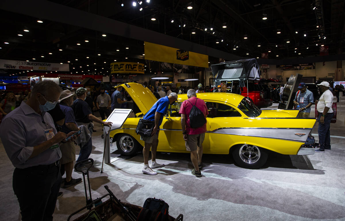 Attendees check out an all-electric 1957 Chevy Bel Air 210 concept, dubbed Project X, at the Ch ...