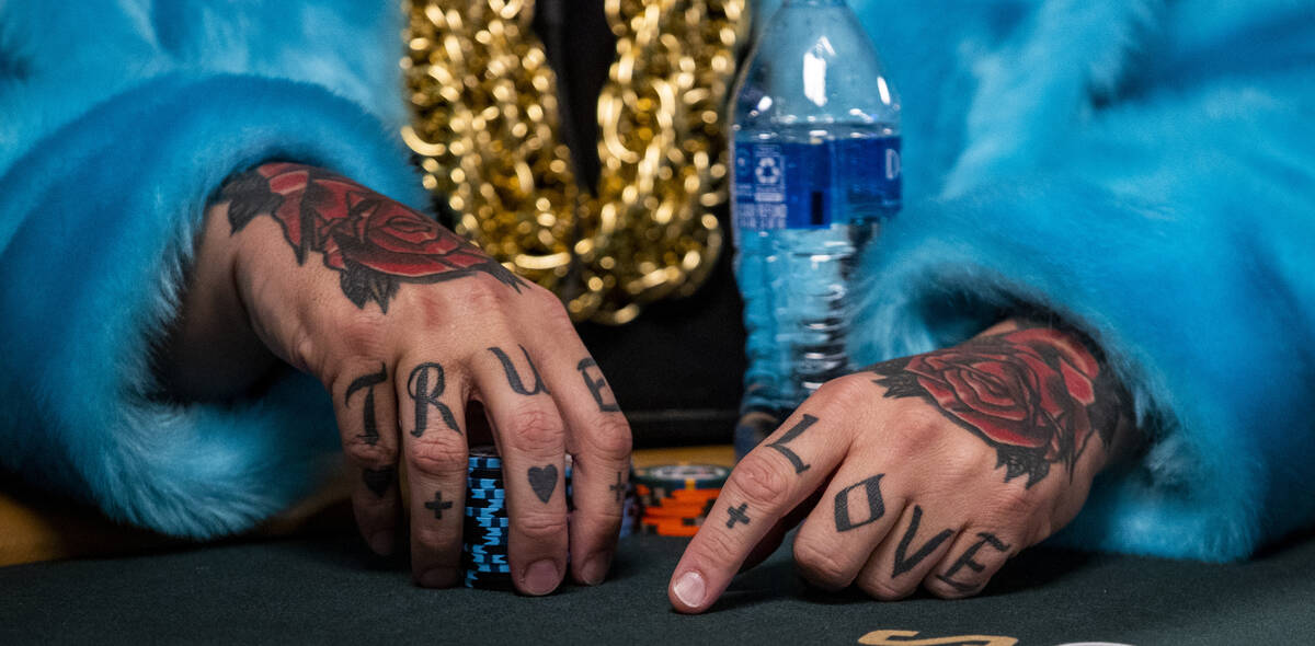 Ryan Snow of Atlanta sports a blue furcoat, gold chains and hand tattoos while playing at his t ...