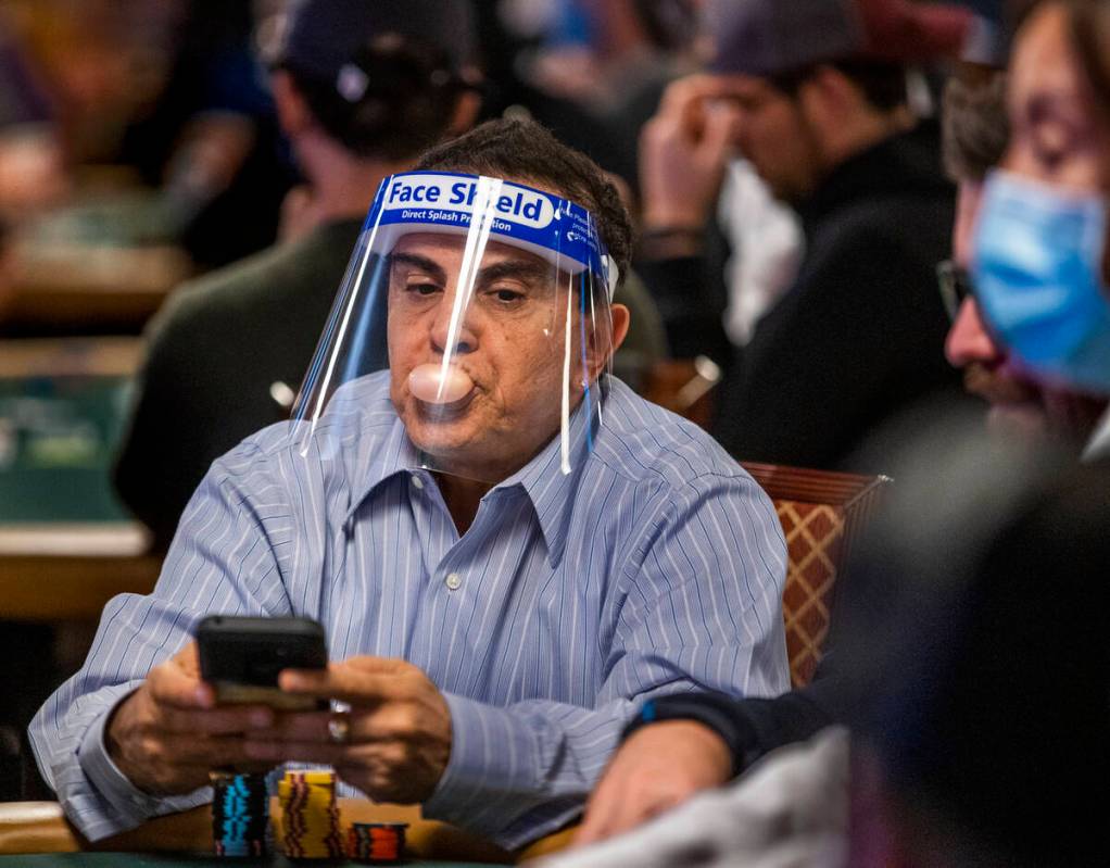 Haim Gabay of Las Vegas blows a bubble while waiting for the next round to be dealt during Day ...