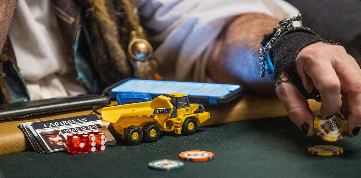 Scotter Clark from Iowa flips some chips while waiting for some cards during Day 1A of the $10, ...