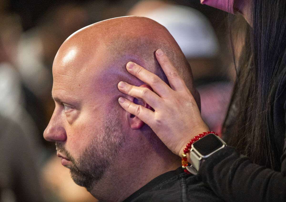 Ryan Snow of Atlanta receives a massage while playing at his table during Day 1A of the $10,000 ...