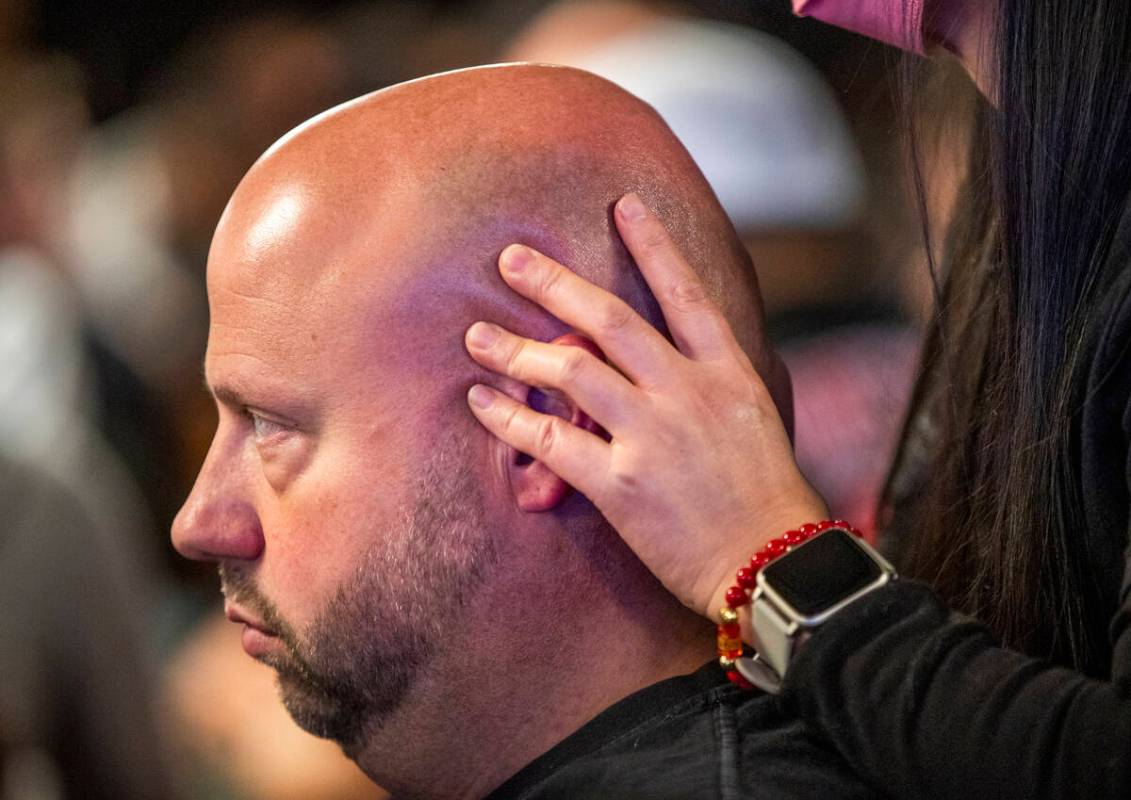 Ryan Snow of Atlanta receives a massage while playing at his table during Day 1A of the $10,000 ...