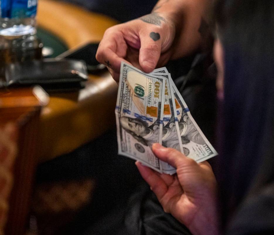Ryan Snow of Atlanta pays a masseuse $300 for a massage while playing at his table during Day 1 ...