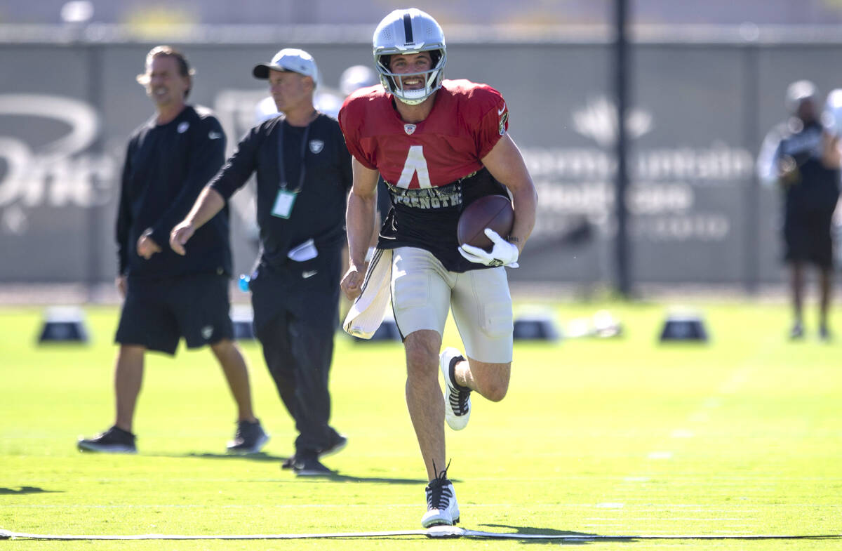 Raiders quarterback Derek Carr (4) smiles as he runs during a practice session at the Raiders H ...