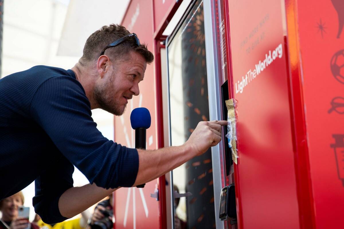 Dan Reynolds of Imagine Dragons donates using the "giving machine," a vending machine that allo ...