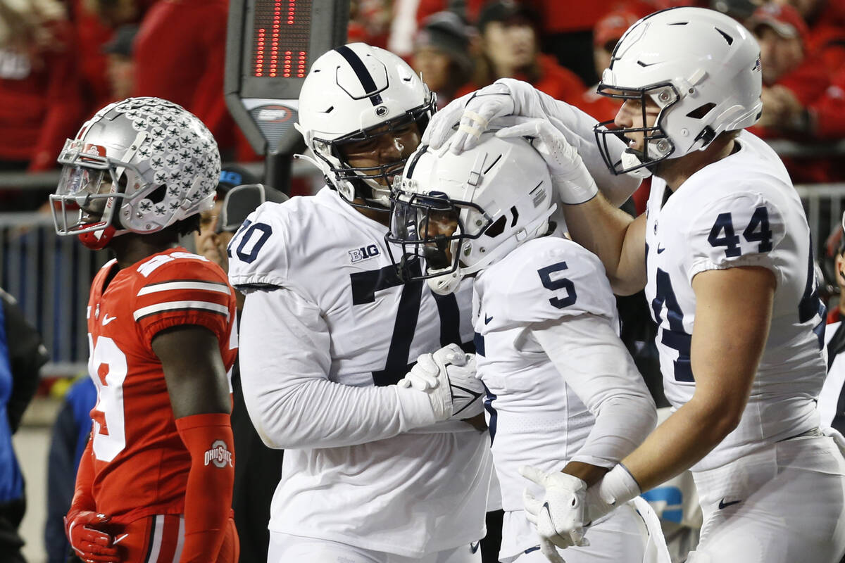 Penn State receiver Jahan Dotson, center, celebrates his touchdown against Ohio State with team ...