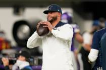 Injured Dallas Cowboys quarterback Dak Prescott stands on the field before an NFL football game ...