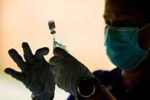 In this Sept. 14, 2021, file photo, a syringe is prepared with the Pfizer COVID-19 vaccine at a ...