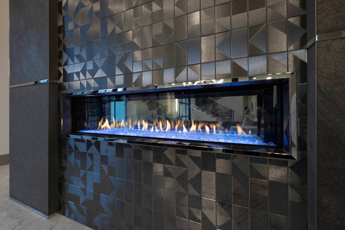 The modern fireplace is a focal point in the living area. (Las Vegas Sotheby’s International ...