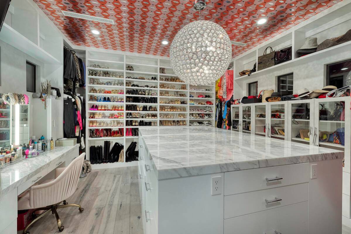 The master closet features Mosaic Artist Allison Eden Smile Lips wallpaper. (Las Vegas Sotheby ...