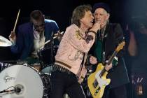 Mick Jagger, center, and Keith Richards of the Rolling Stones share vocals during the band's pe ...