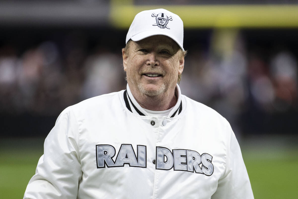 Mark Davis, owner of the Raiders, walks to the field before an NFL football game between the Ch ...