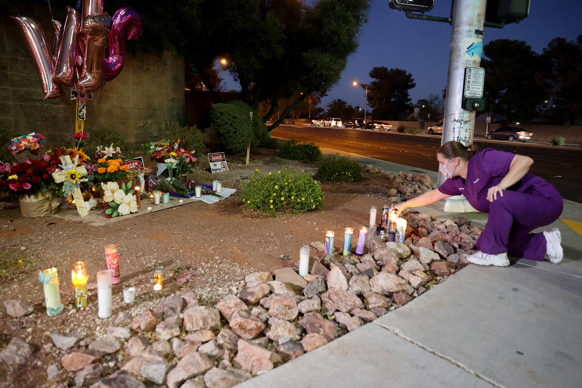 Jennifer Williams of Henderson lights candles at a memorial for Tina Tintor and her dog Max at ...