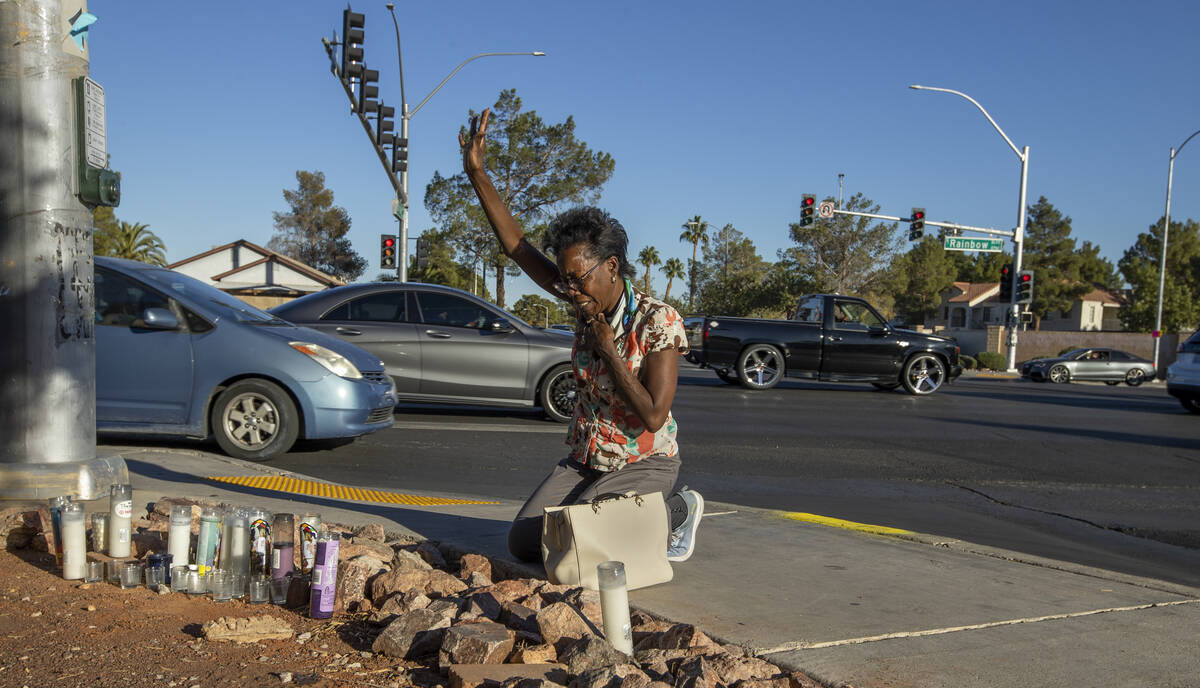 Renee Jimenez prays after lighting a candle at a roadside memorial for Tina Tintor near the acc ...