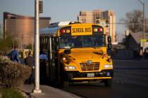 Police investigate the scene of a fatal pedestrian crash involving a school bus near West Deser ...