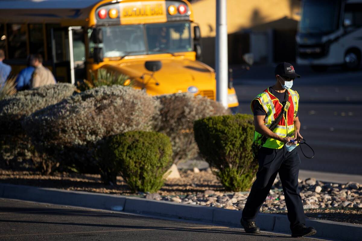 A paramedic walks the scene of a fatal pedestrian crash involving a school bus near West Desert ...