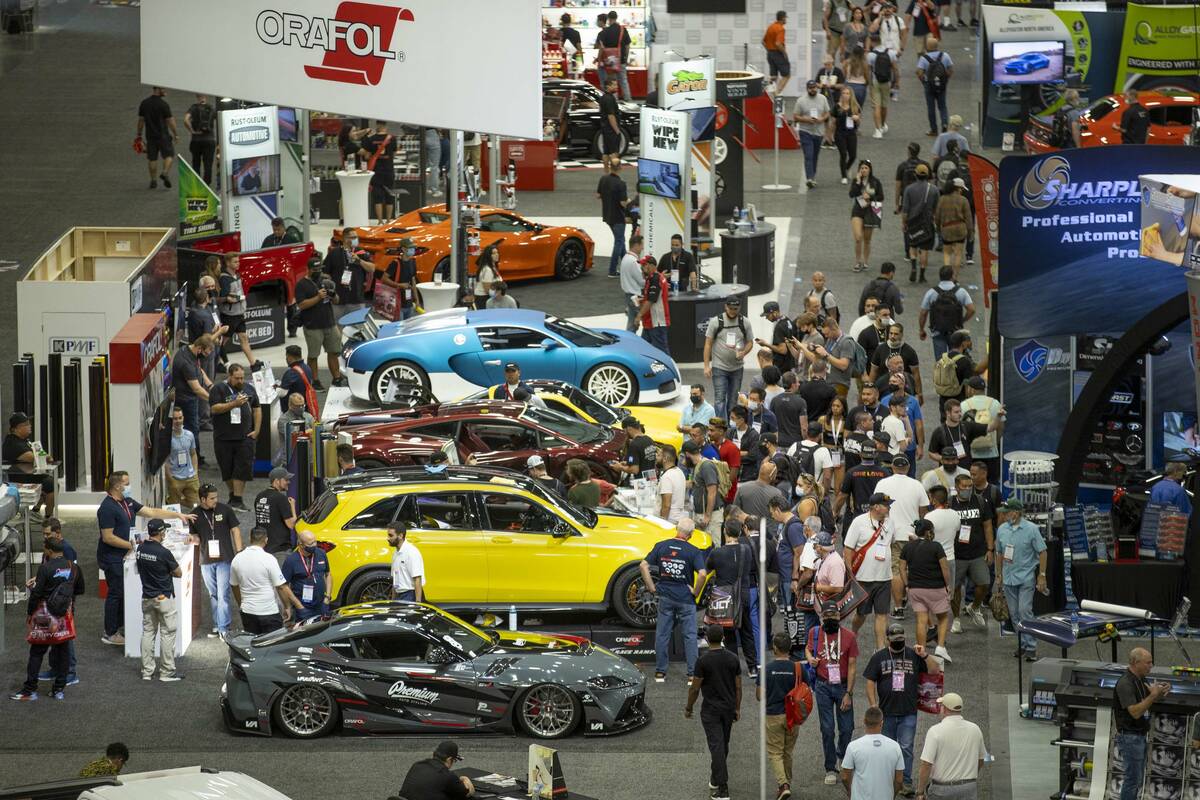 Attendees walk about the West Hall during SEMA at the Las Vegas Convention Center on Friday, No ...